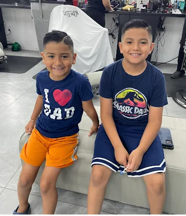 Two young kids after fresh haircuts